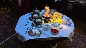 A table set with fine china, silverware, and a lit candle, suggesting a formal dining setup. - Hotel Victoria (Schlangenbad)