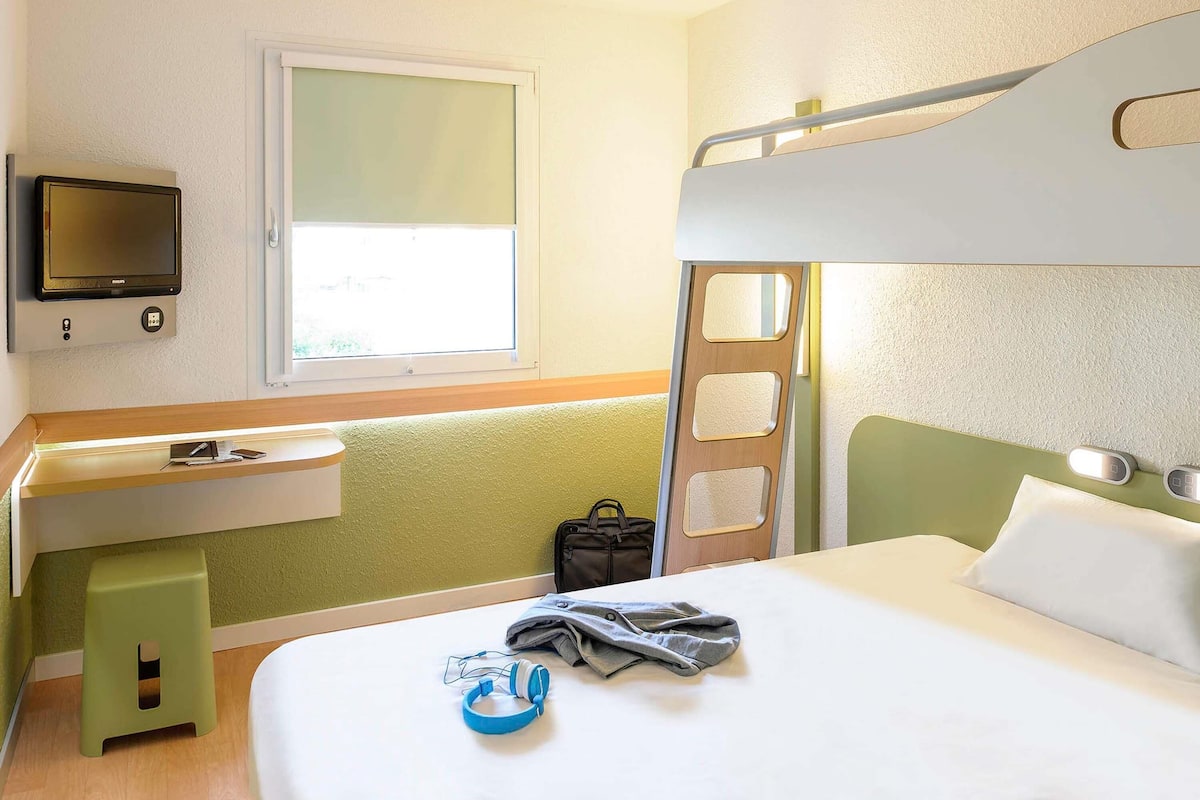 Premium bedding, desk, laptop workspace, blackout drapes