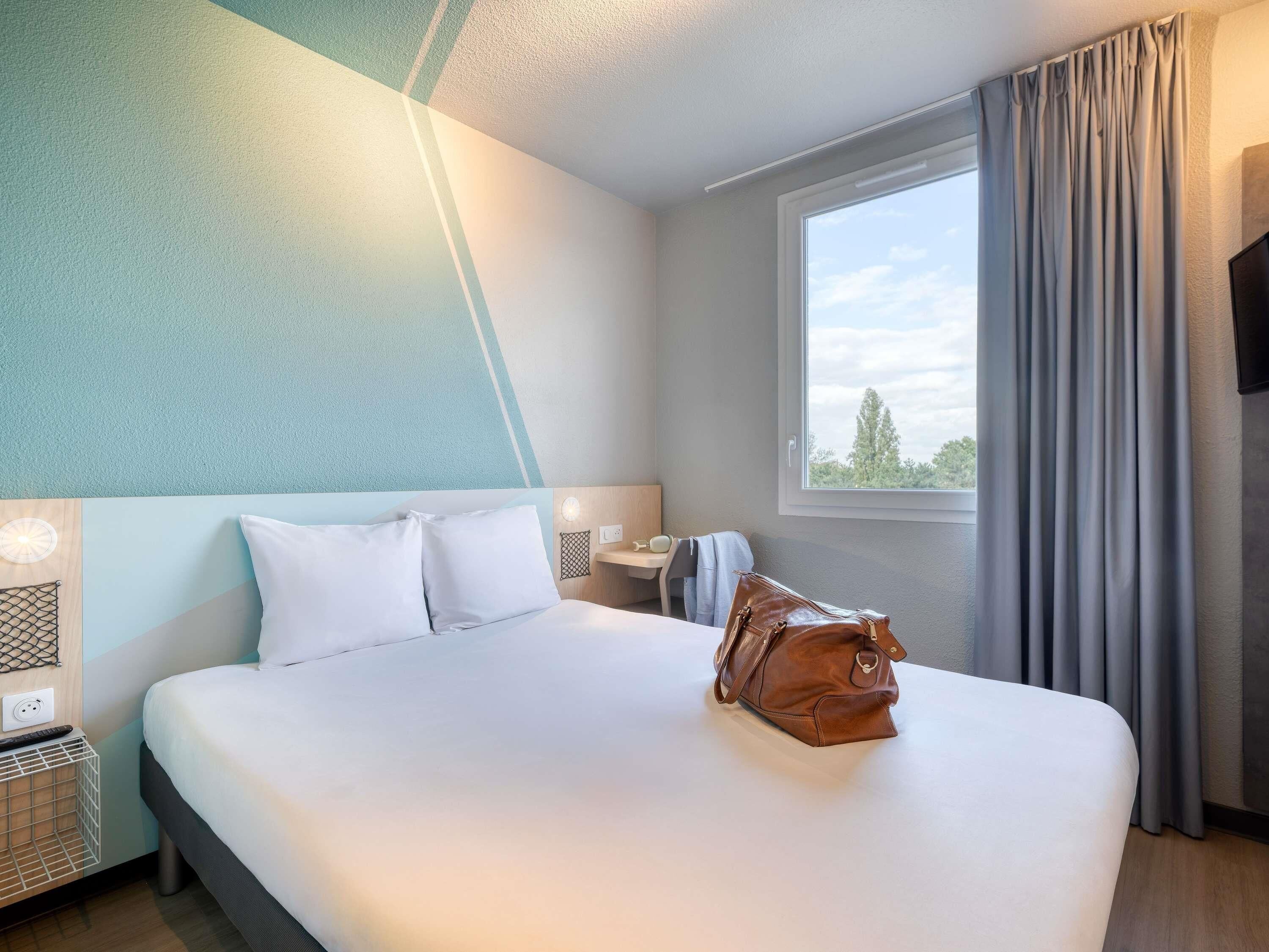 Premium bedding, desk, laptop workspace, blackout curtains