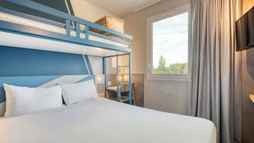 A bunk bed room with a window and curtains.