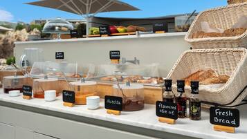 A breakfast buffet with various food items and condiments.