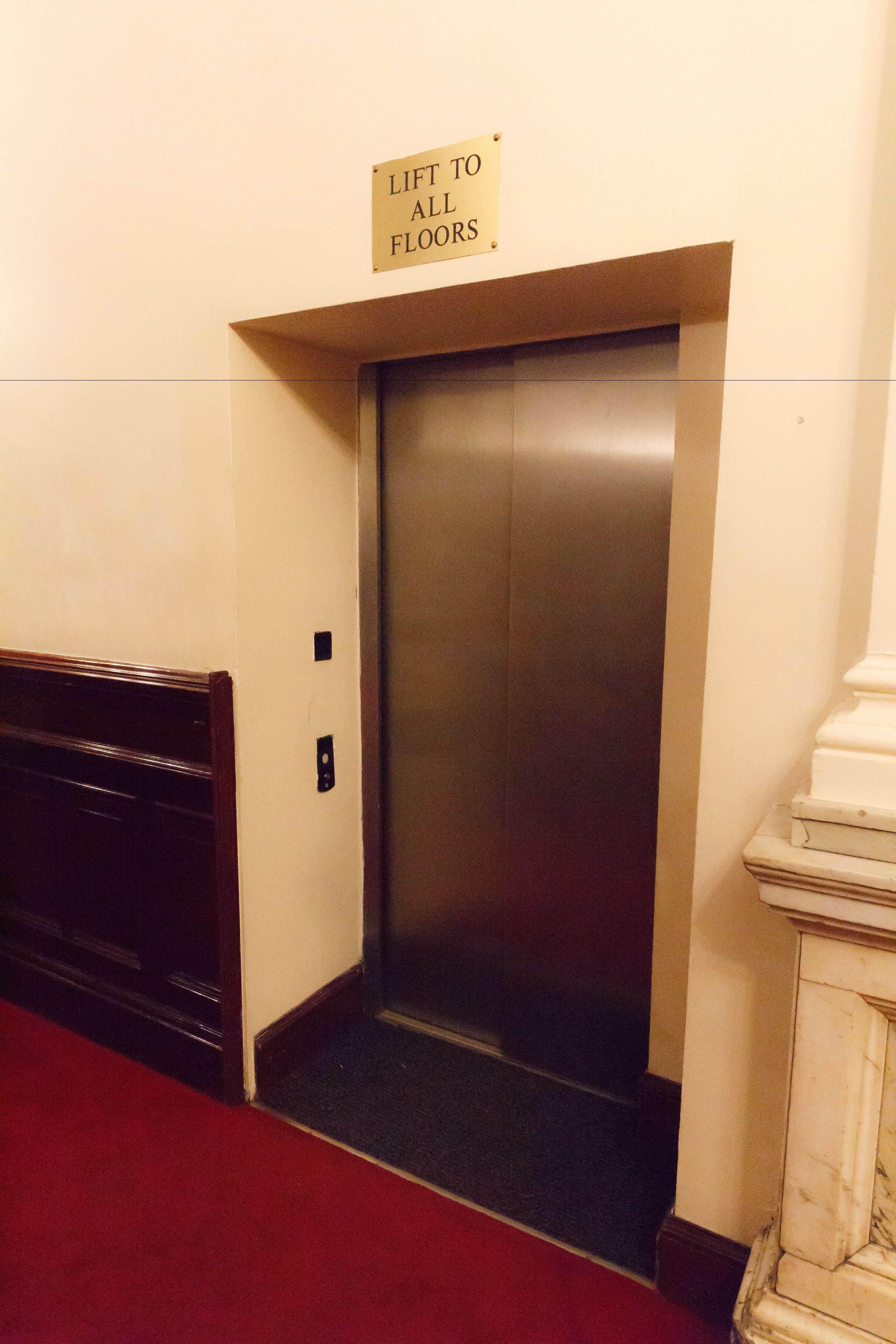 An elevator with a sign above it that reads "LIFT TO ALL FLOORS."