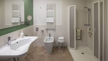 Een moderne badkamer met een groot wastafel, toilet met douchefunctie en ruime douche.