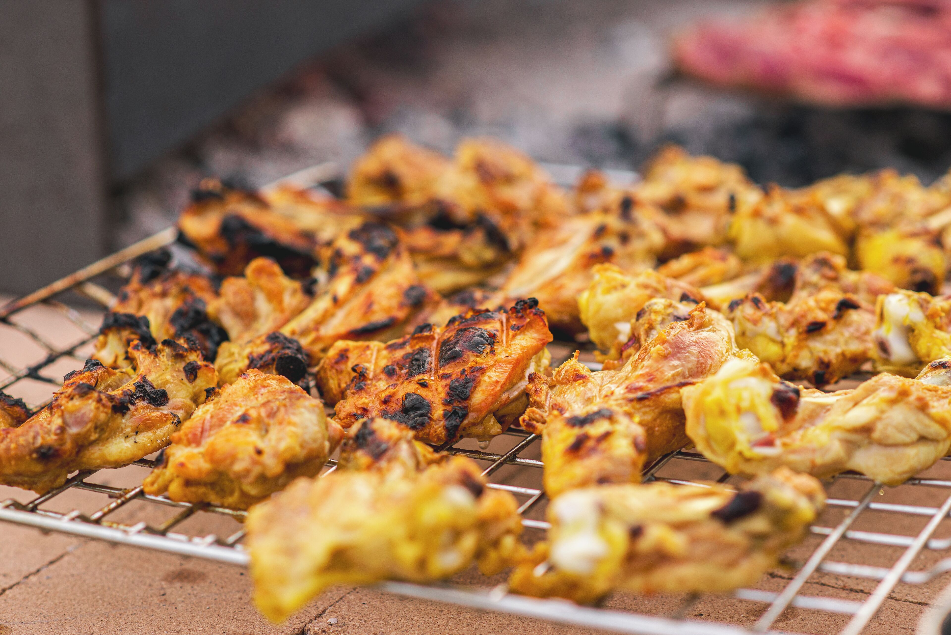 Grilled chicken skewers on a wire rack.