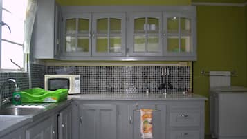 Tobago Apartment | Private kitchen | Fridge, microwave, stovetop