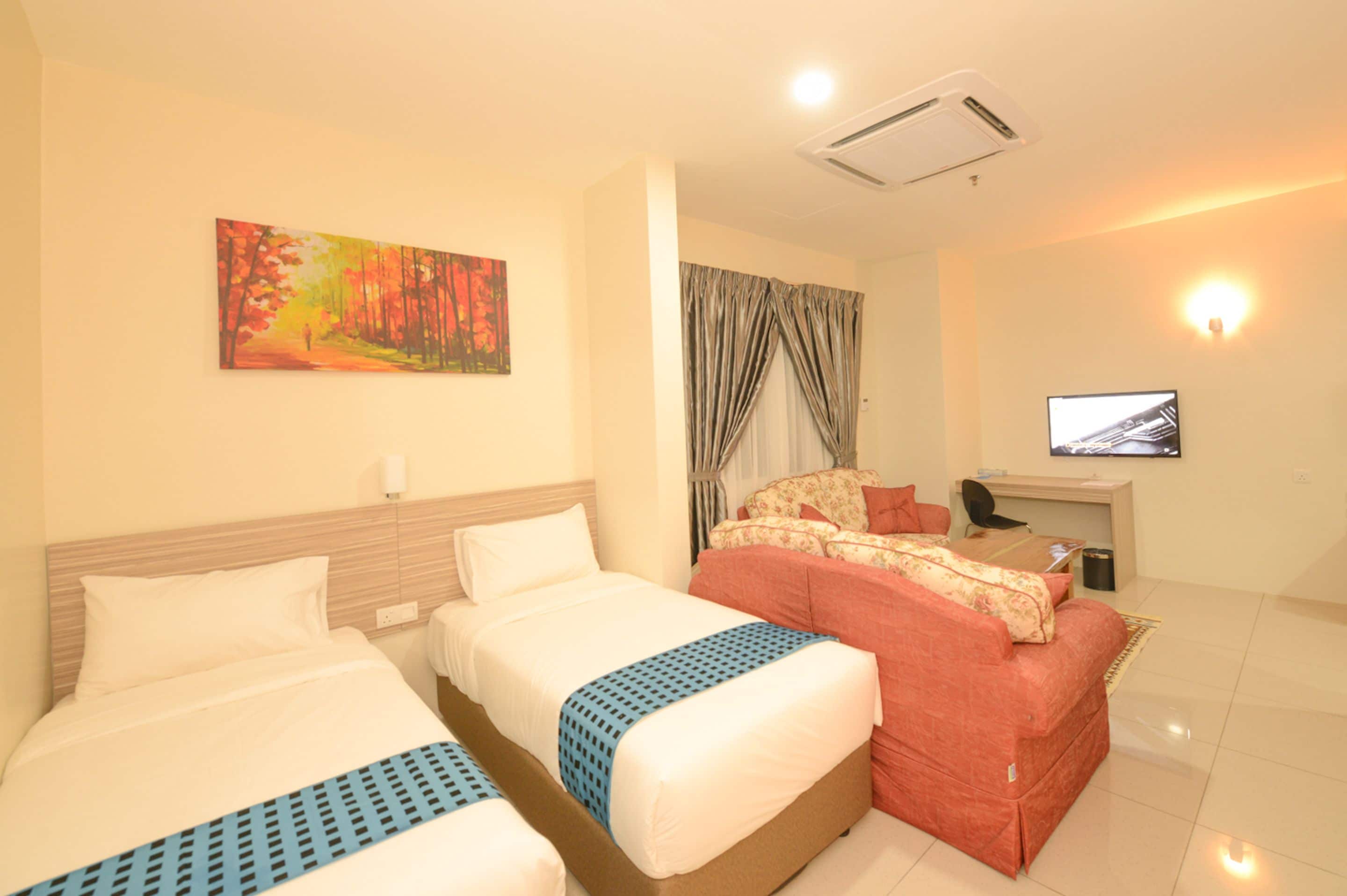 A hotel room with two beds, a sofa, a TV, and a painting on the wall.