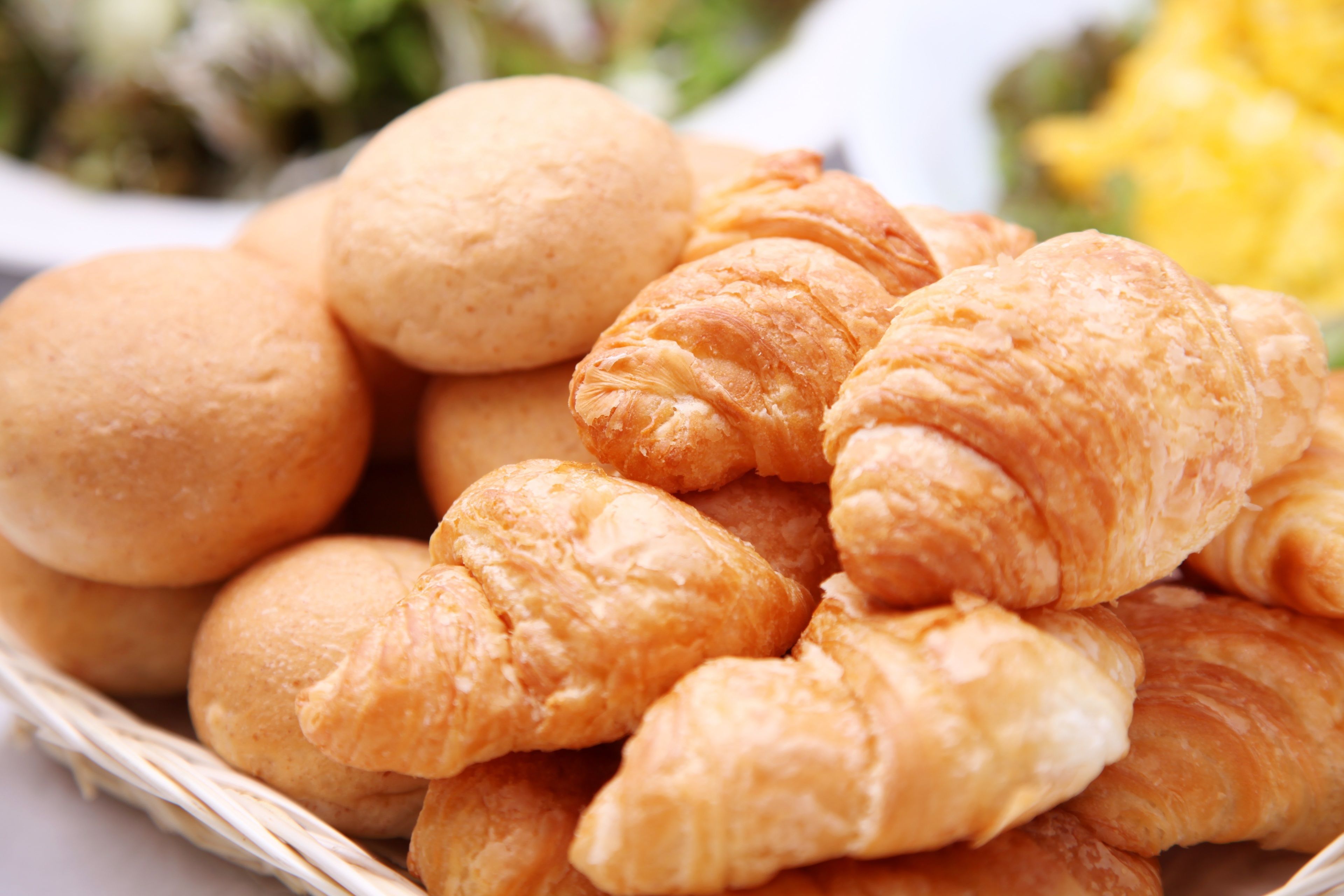 A basket of golden-brown croissants.