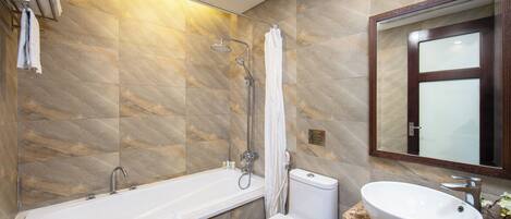 A modern bathroom with a bathtub, toilet, and sink.