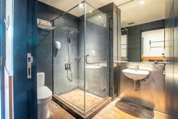 A modern bathroom with a glass-enclosed shower, a white sink, and a toilet. - Yellow Bee Tangerang (Tangerang)