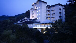 A multi-story hotel with a modern design, featuring a prominent tower and multiple balconies.