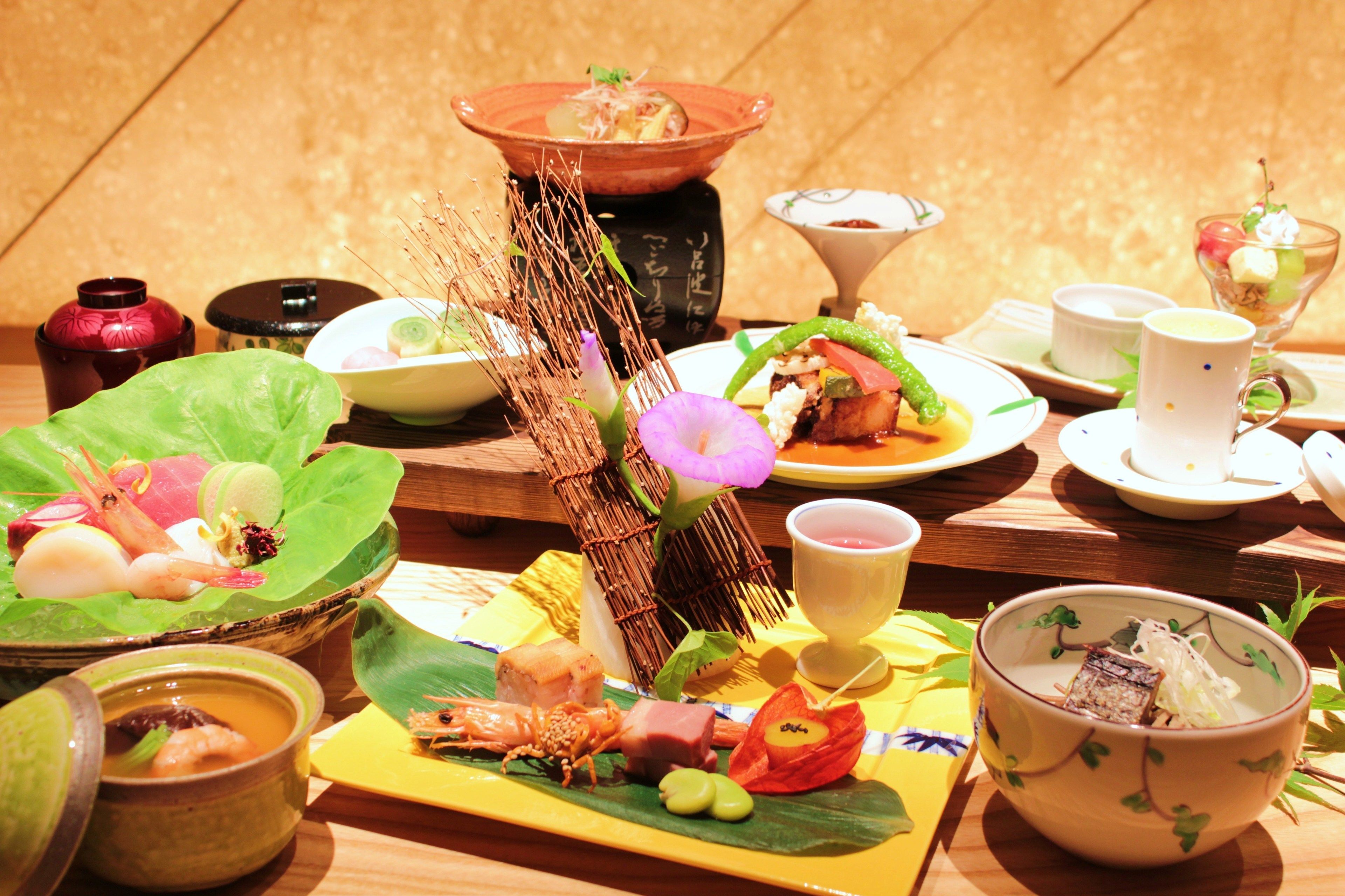 A traditional Japanese meal with various dishes and utensils on a wooden table.