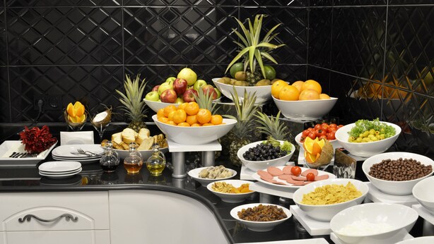 A buffet table with various food items and condiments. - Arus Hotel (Eskisehir)
