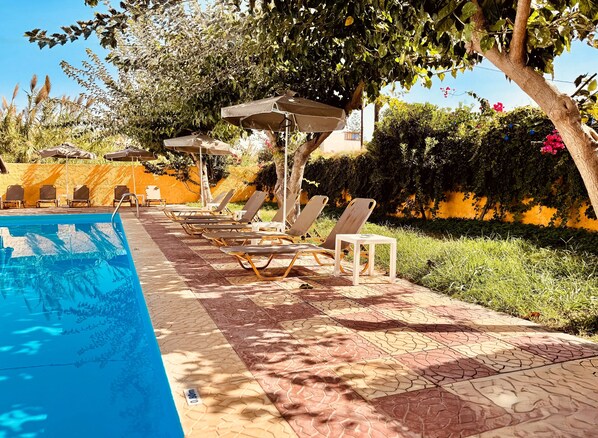 Seasonal outdoor pool, pool umbrellas, pool loungers