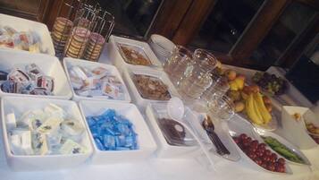 A buffet table with various food items and containers.