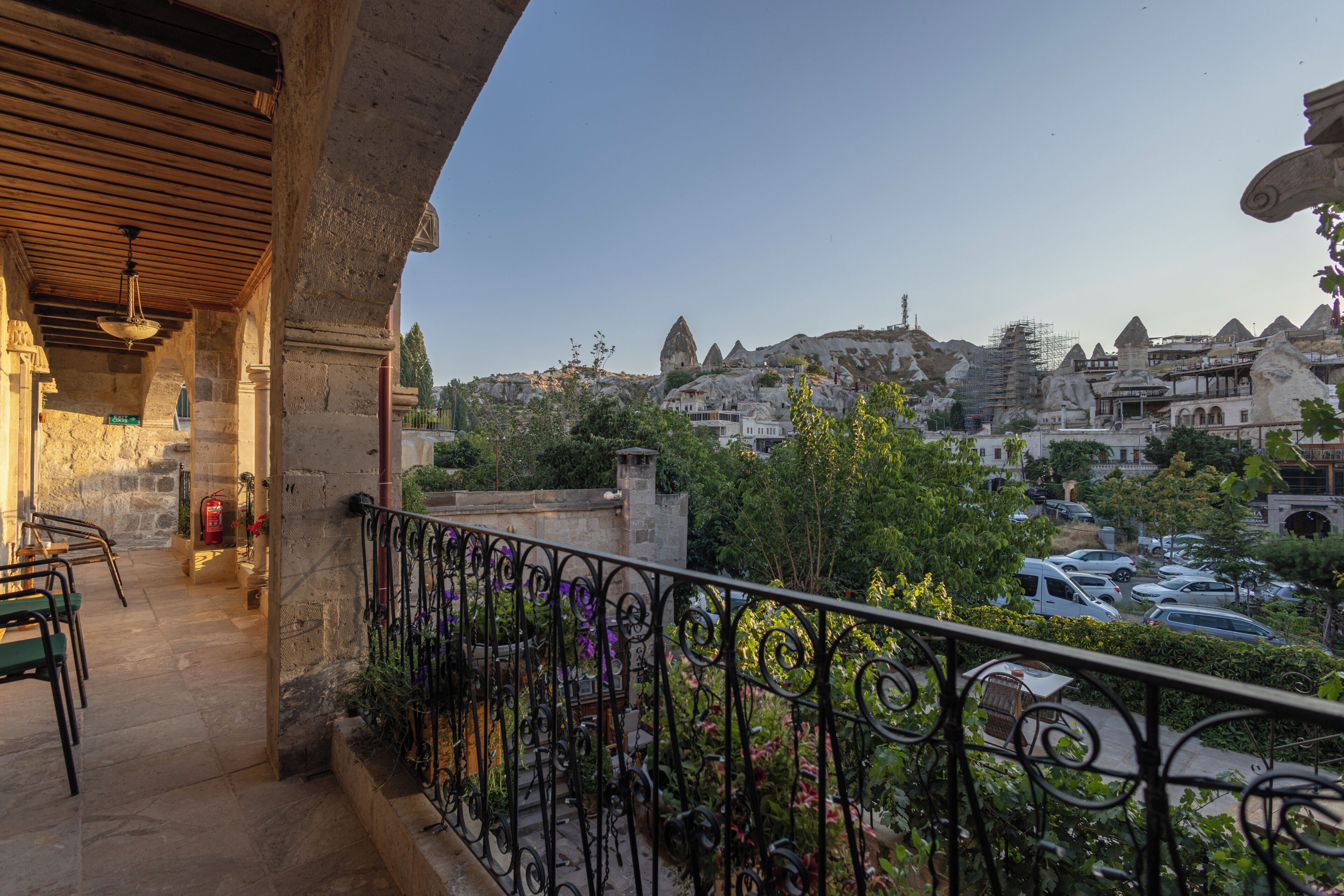 A balcony with a view of a mountainous landscape and a river.