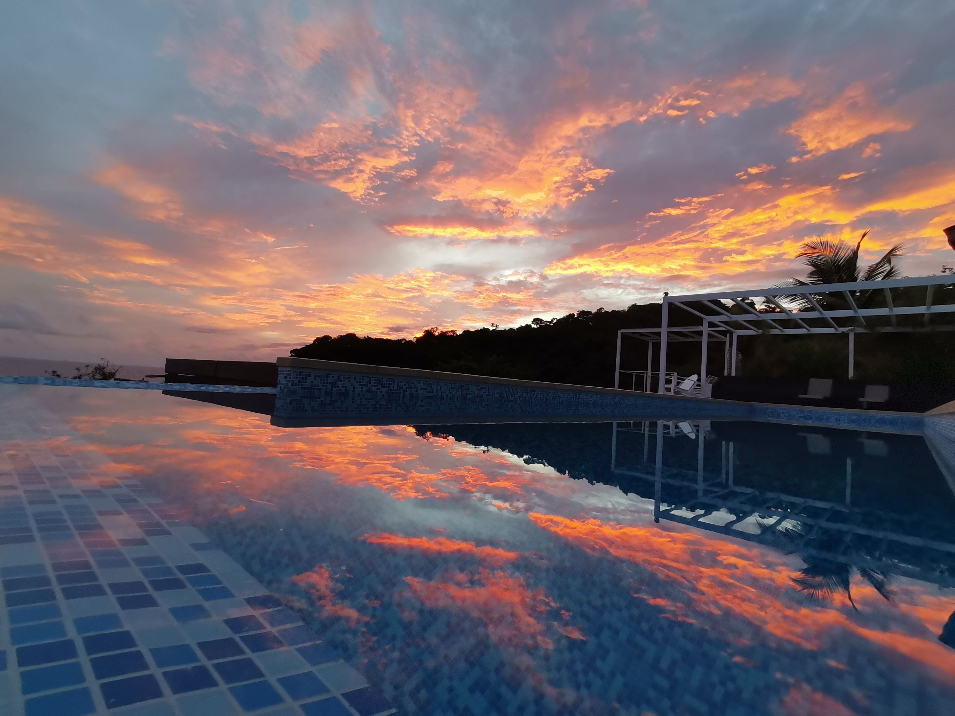 Outdoor pool, an infinity pool, open 6:00 AM to 9:00 PM, pool umbrellas