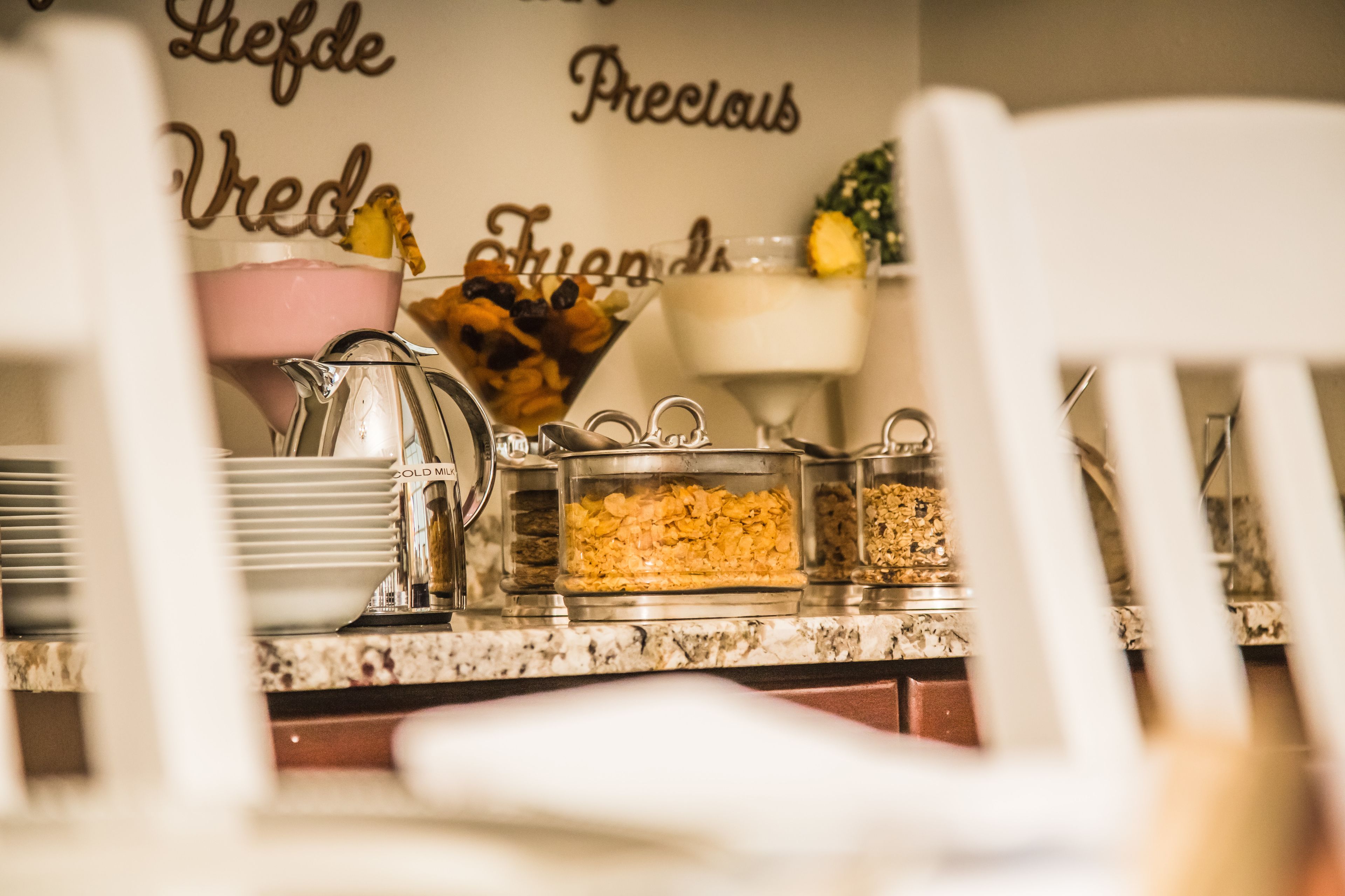 A breakfast buffet with various food items and a coffee station.