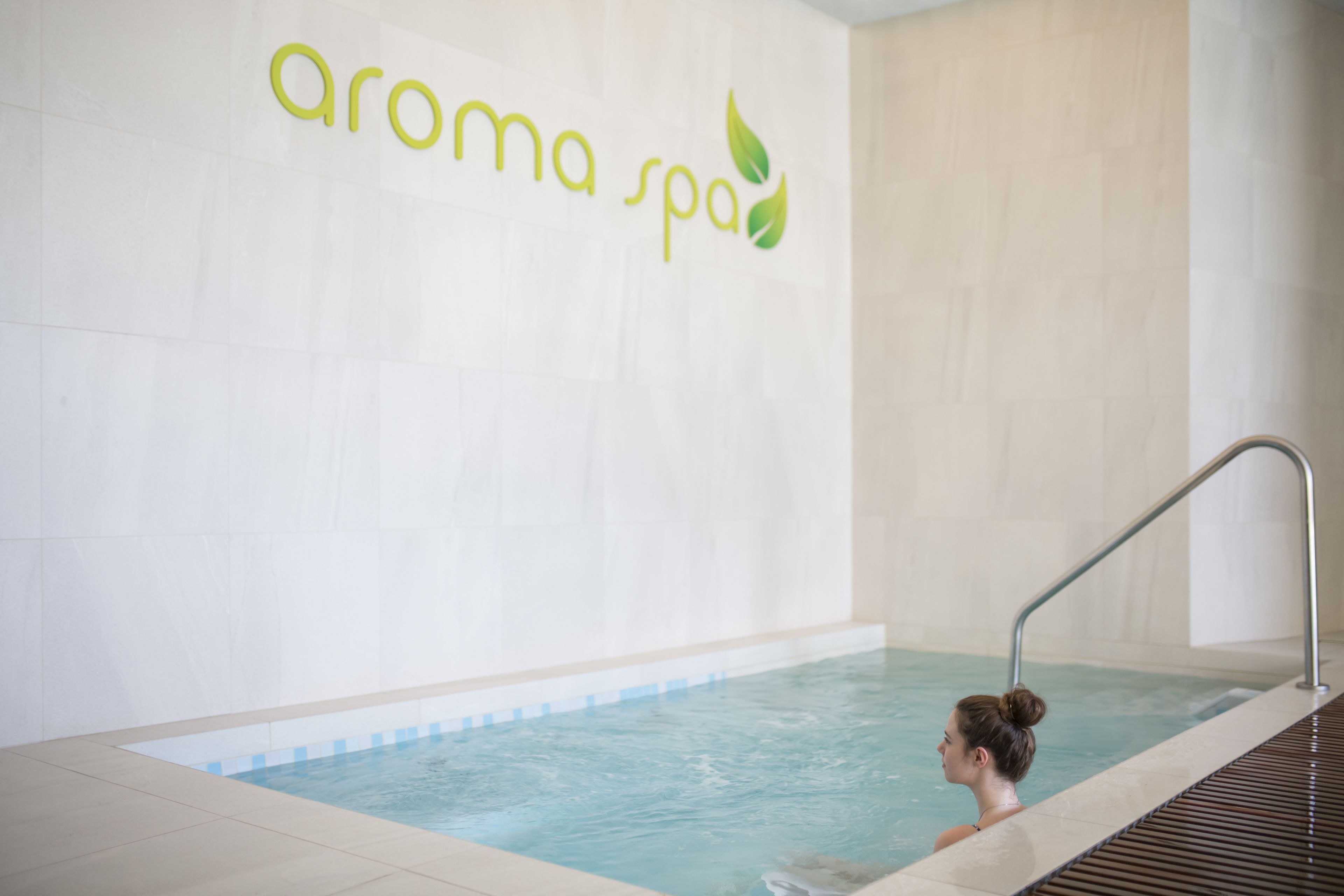 A spa with a pool and a sign that reads "aroma spa".