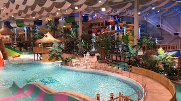 Enjoy a fun-filled day at the central pool surrounded by water slides and play areas, with seating for relaxation.