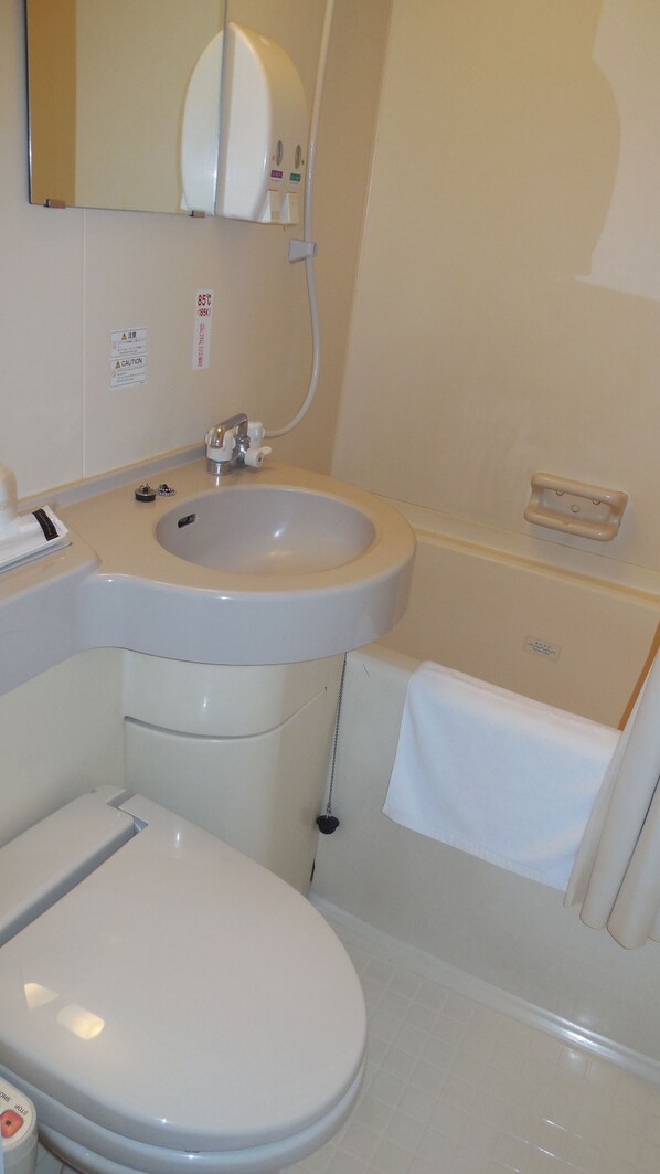 Une salle de bain avec des toilettes, un lavabo et une baignoire.