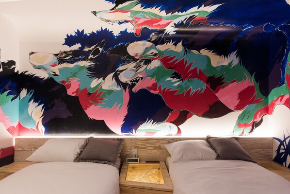 A bedroom with two beds, a large abstract mural on the wall, and a wooden headboard.
