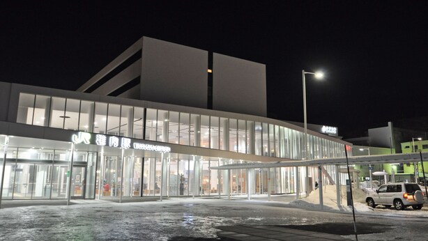 A modern building with a glass facade and a covered entrance area. - Hotel Saharin (Wakkanai)