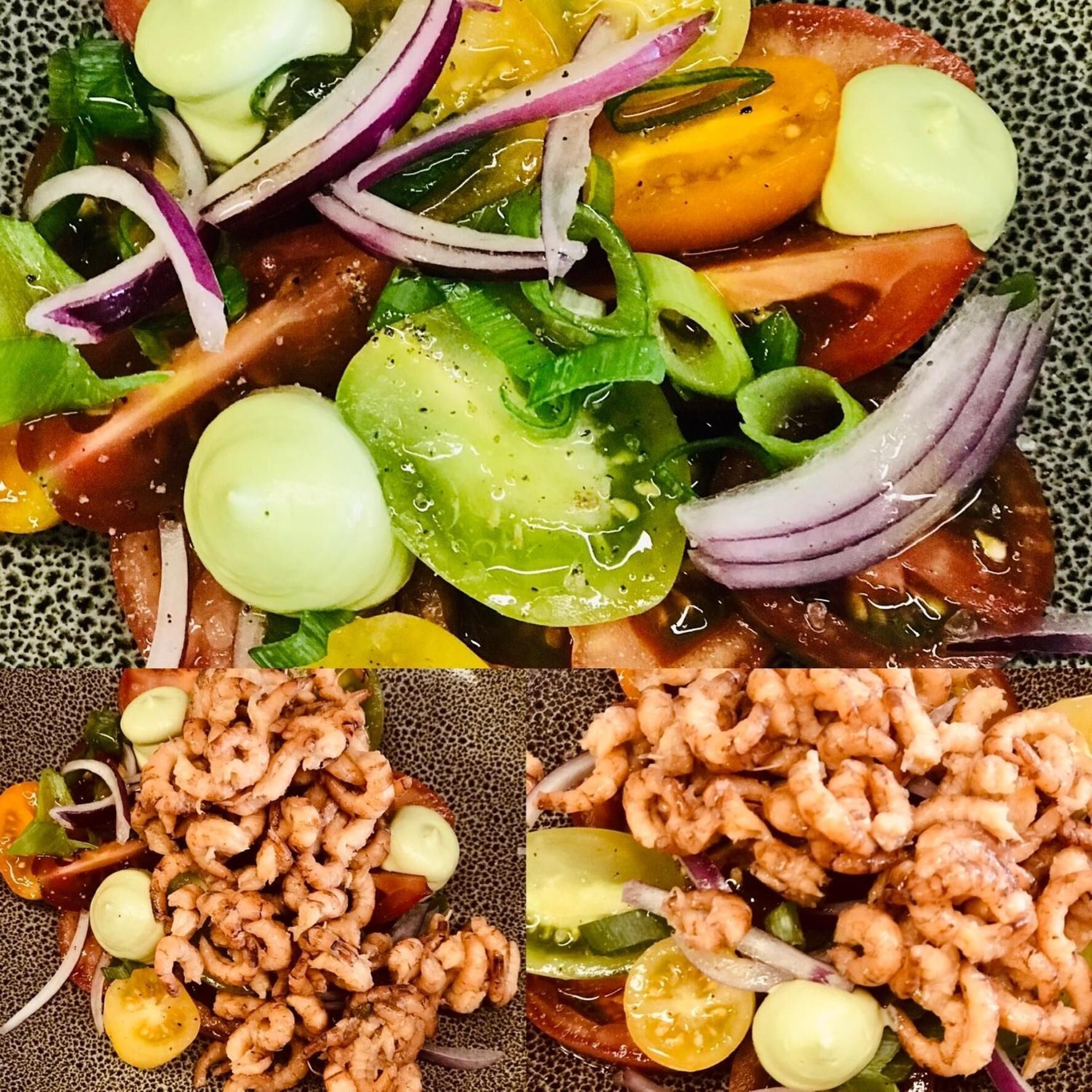 A seafood dish with shrimp, tomatoes, onions, and cucumbers.