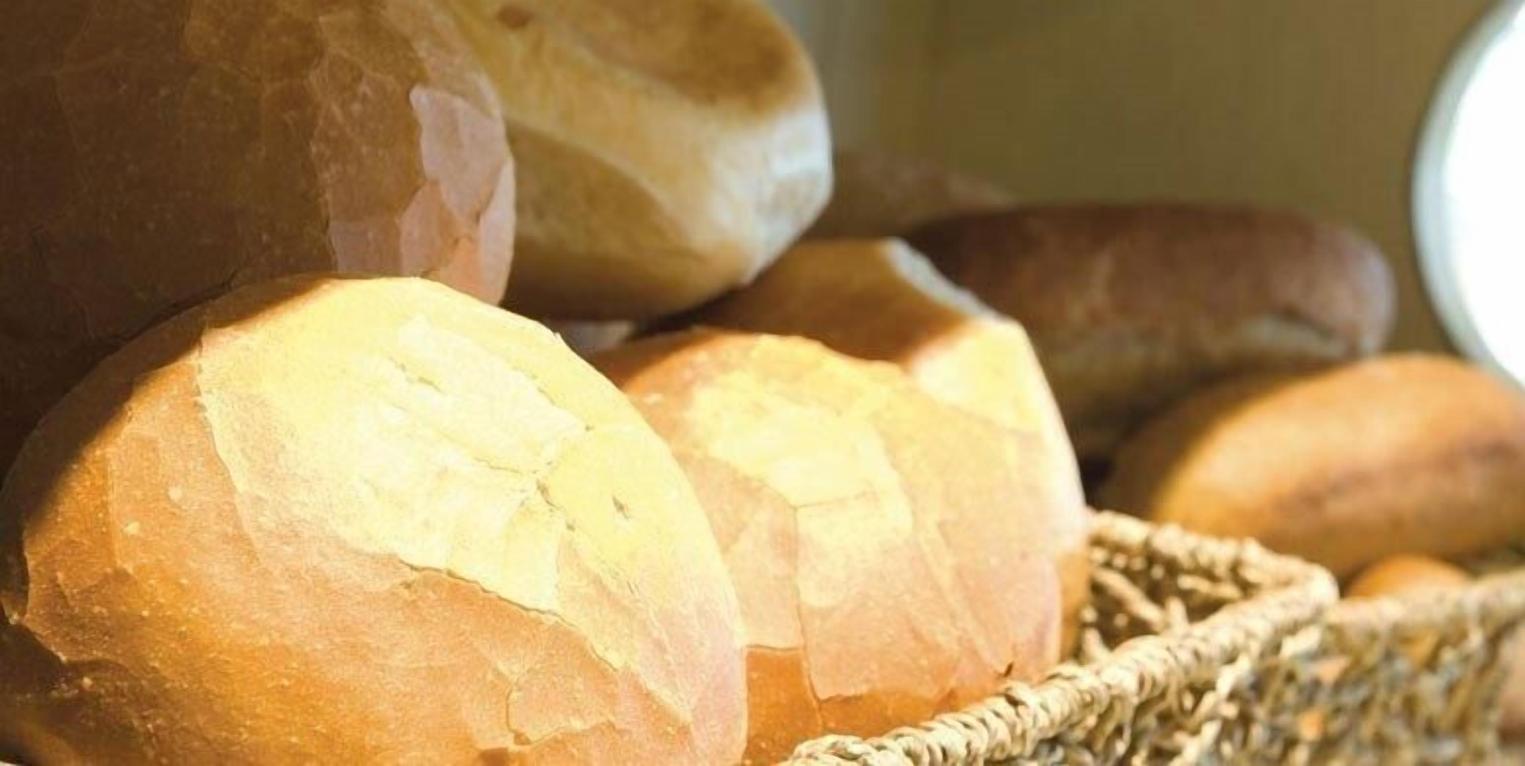 A basket of freshly baked bread rolls.