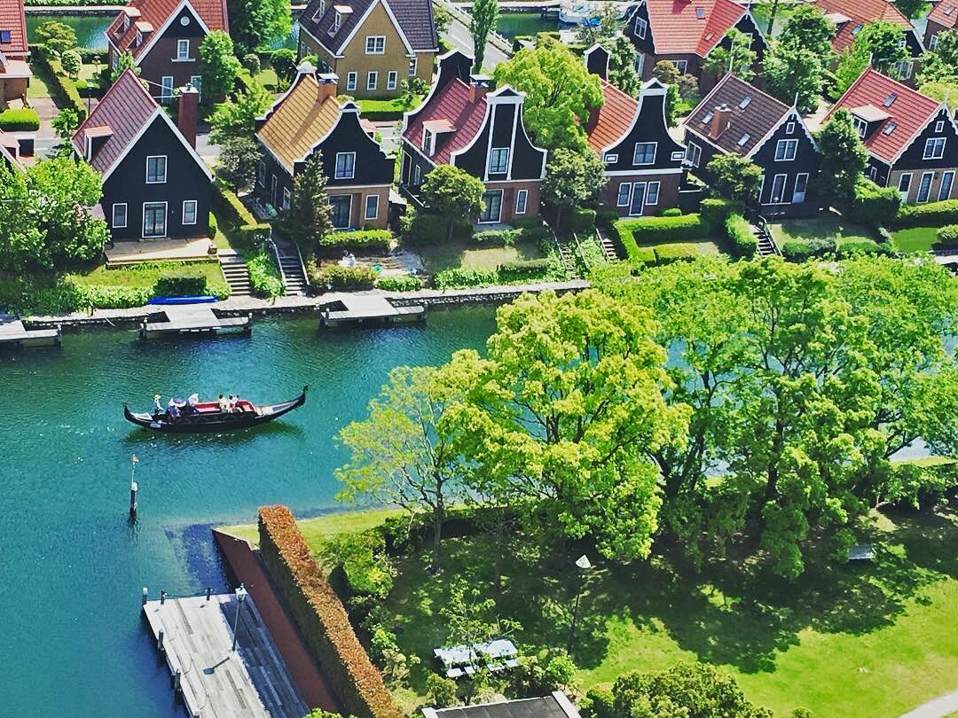 A canal with houses and a gondola.