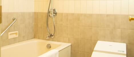 A bathroom with a bathtub, a toilet, and a shower.