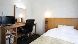A hotel room with a bed, a desk with a computer, a chair, a small refrigerator, and a mirror. - Finedays Hotel (Ina)
