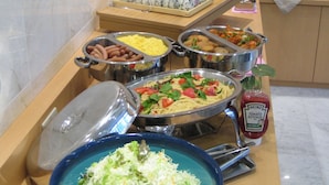 A buffet with various food options including salads, pasta, and meats. - Finedays Hotel (Ina)