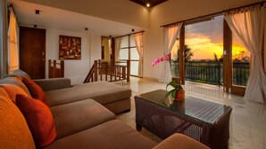 A spacious living area with a sofa set, a glass-top coffee table, and a balcony with curtains. - Balangan Beach Villa (Jimbaran)