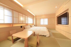 A modern hotel room with tatami flooring, a bed, a TV, and a small table. - Richmondhotel Kagoshima Kinseicho (Kagoshima)