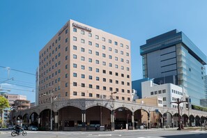 Situated on a street corner, The Richmond Hotel features a classic, symmetrical facade with evenly spaced windows.