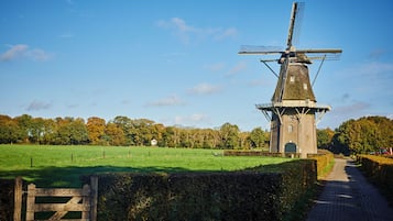 A windmill in a rural setting with a clear sky.