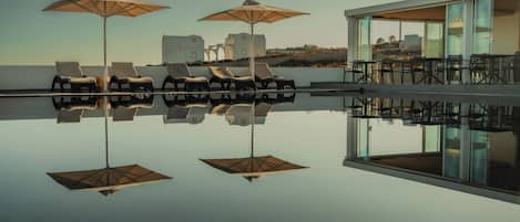 Outdoor pool, open 9 AM to 9:30 PM, pool umbrellas, pool loungers