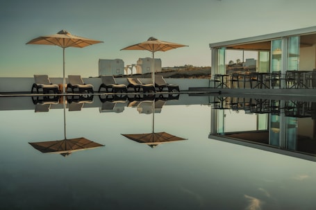 Outdoor pool, open 9 AM to 9:30 PM, pool umbrellas, sun loungers. Serenità Luxury Suites