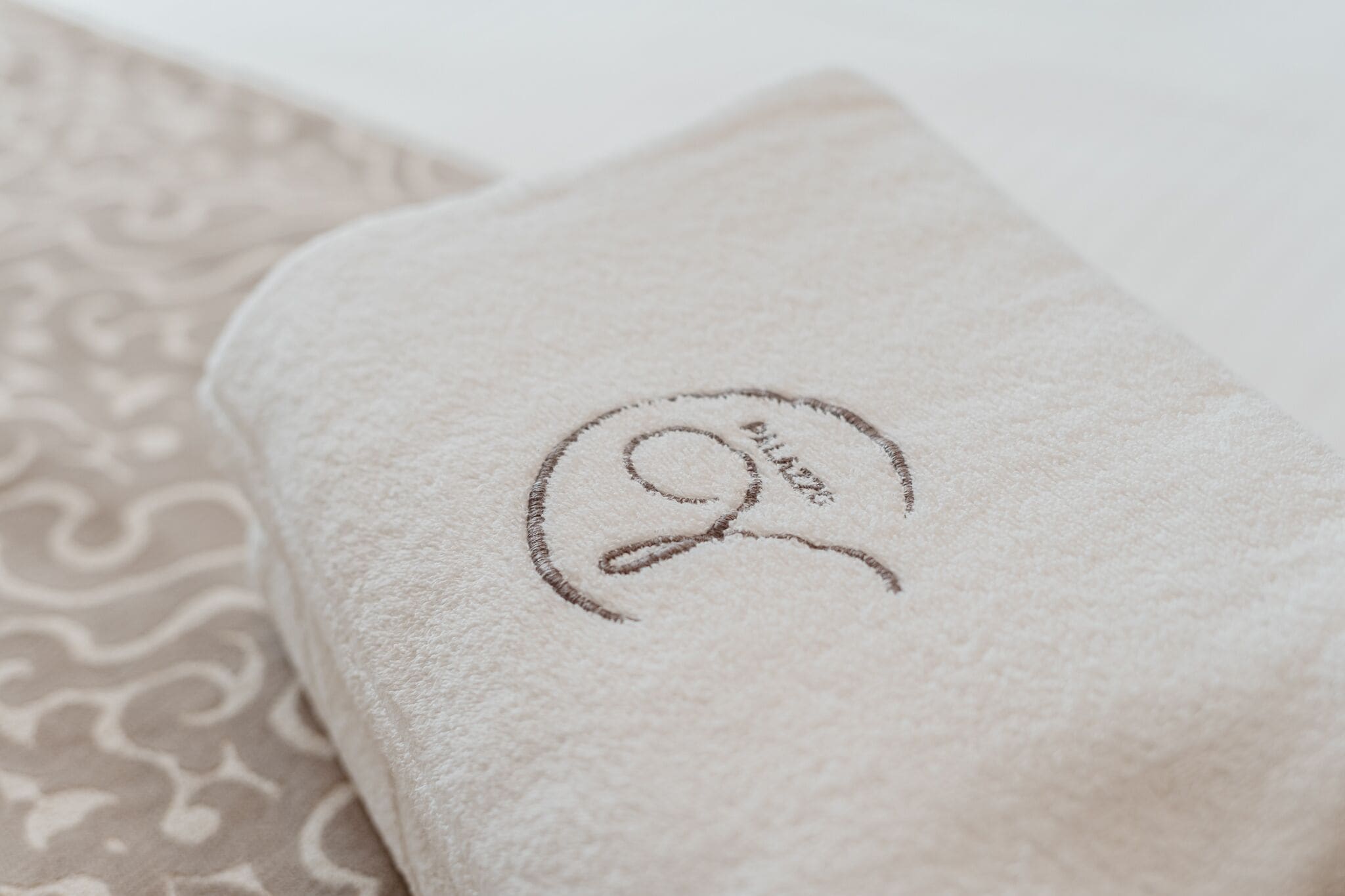 A folded towel with a monogram.