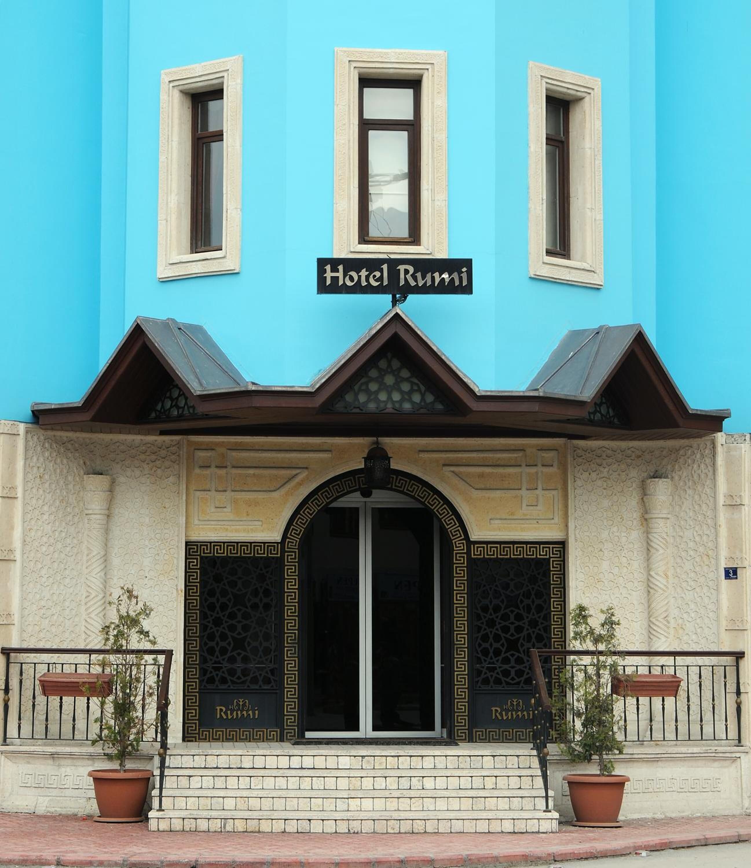 A building with a sign reading "Hotel Rumi" above the entrance.