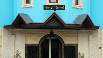 A building with a sign reading "Hotel Rumi" above the entrance.