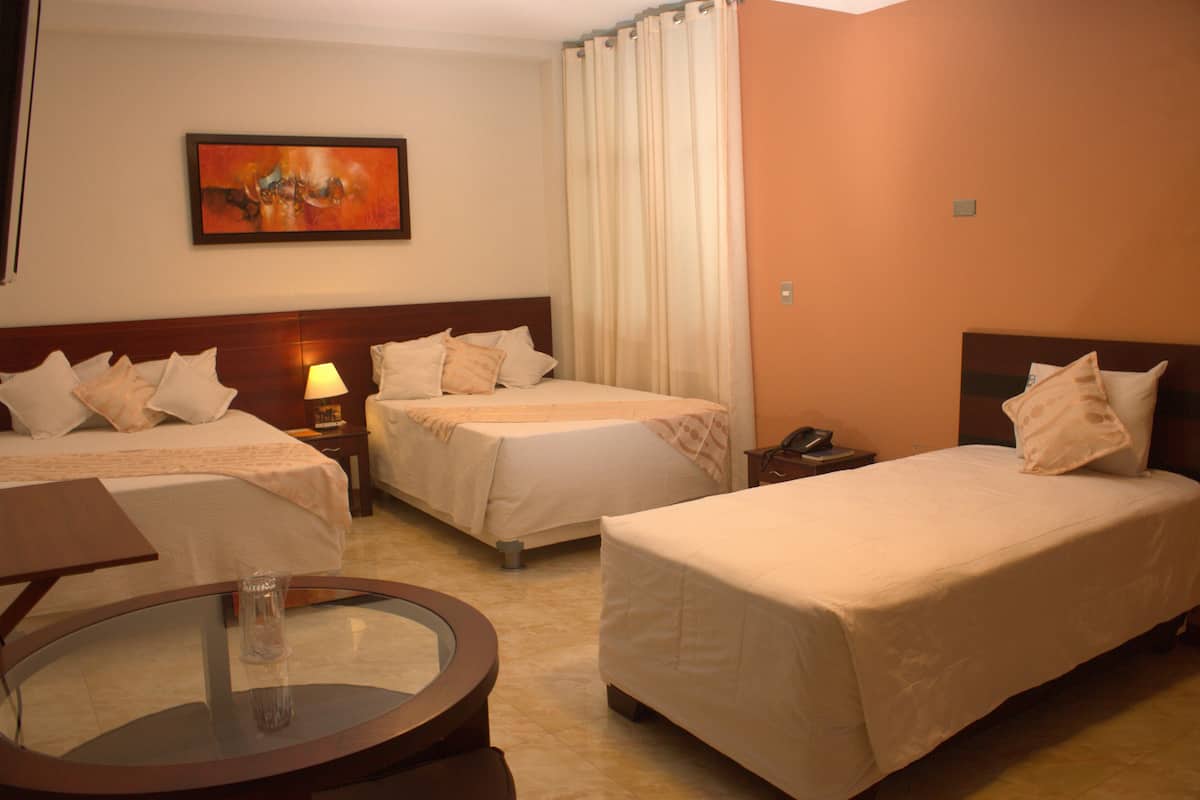Deluxe Triple Room | Minibar, in-room safe, desk, laptop workspace