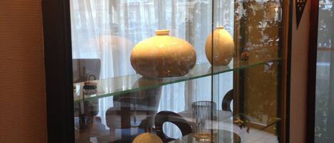 A room with a glass display case containing various decorative items.