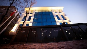 A modern building with large glass windows and a stone facade. - Anka City (Ankara)