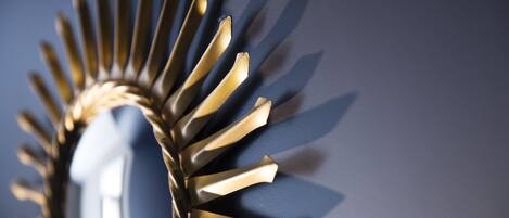 A close-up of a metallic, sunburst-like structure with a reflective surface.