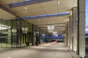 A modern hotel entrance with glass walls, a tiled floor, and a chandelier. - The St. Regis Kuala Lumpur (Kuala Lumpur)