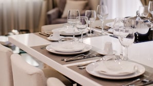 A dining area with a table set for four, including plates, glasses, and cutlery. - MyFlorenceHoliday Gold Bridge (Florence)