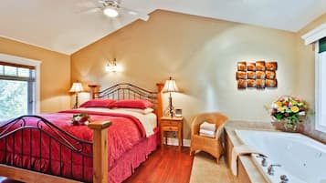 Un dormitorio con cama, lámparas de noche, una silla, tocador y bañera.