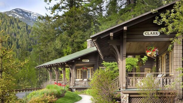 A lodge with a covered porch and a sign reading "CLARK". - Belton Chalet (West Glacier)