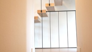 A modern staircase with wooden steps and a metal railing. - JejuSorang (Jeju City)